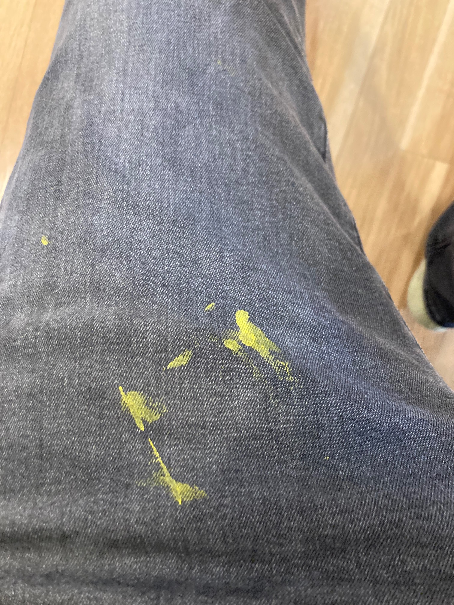 Black jeans with yellow paint