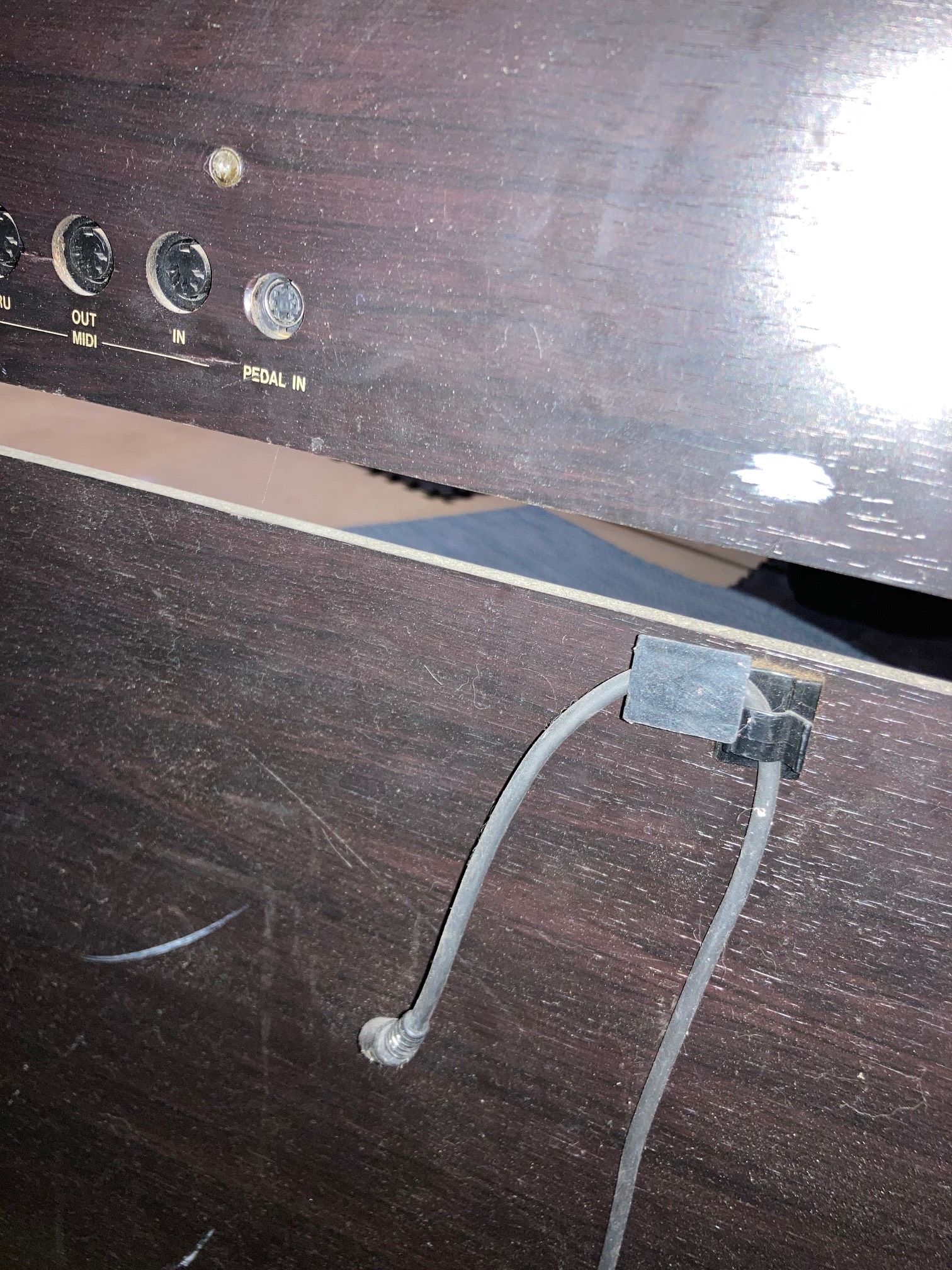 Back of piano with cord disconnected from port