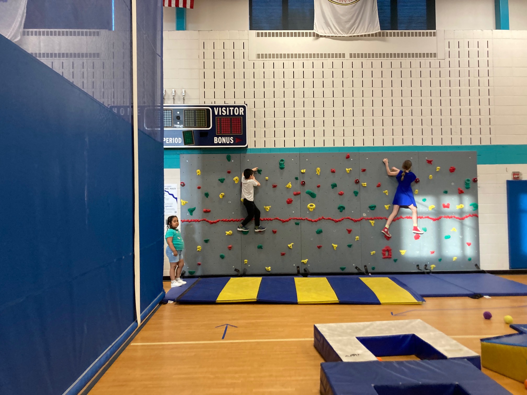 Two kids on school climbing wall
