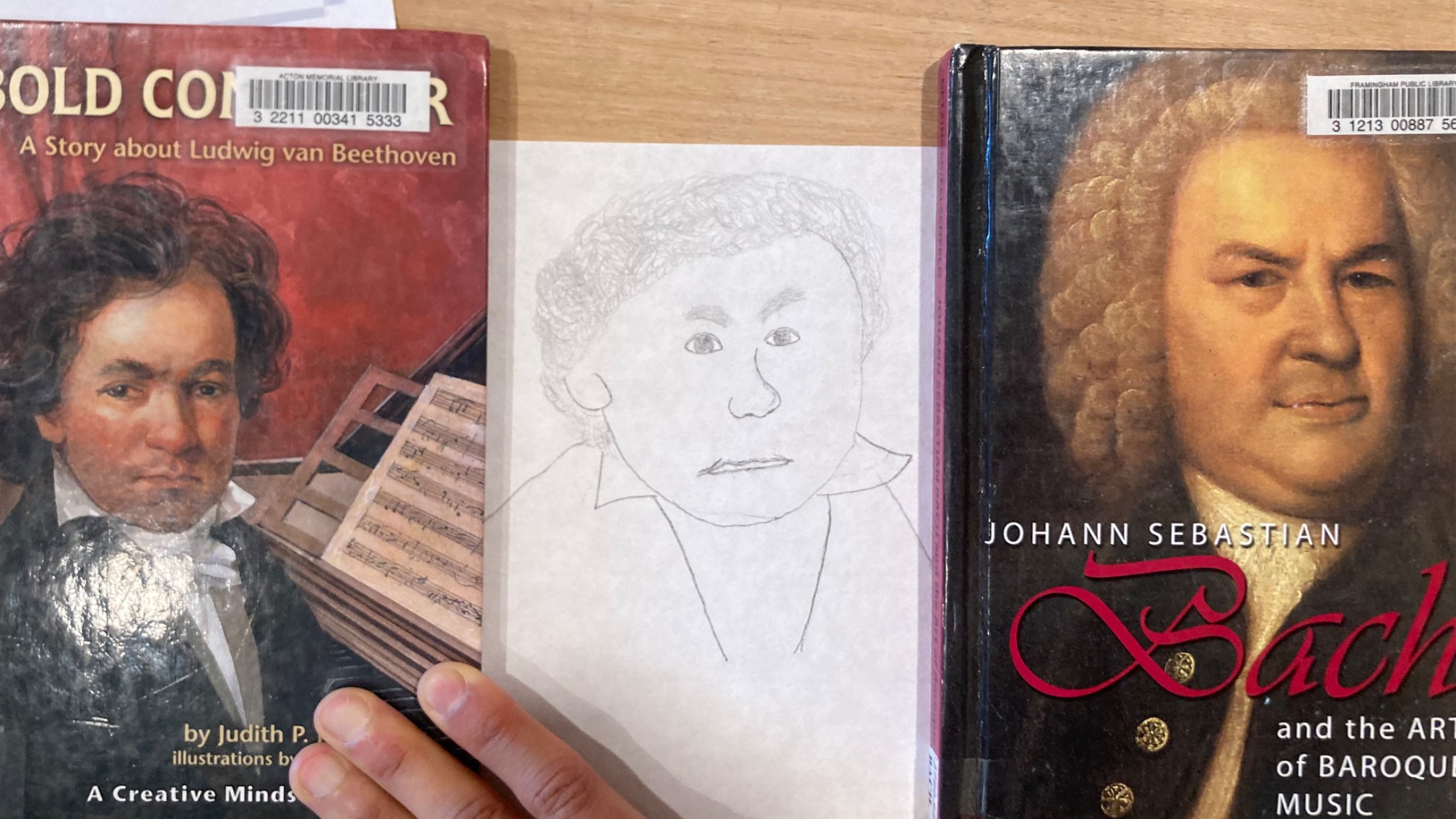Book with Bach on the cover, child’s drawing of a composer, book with Beethoven on the cover
