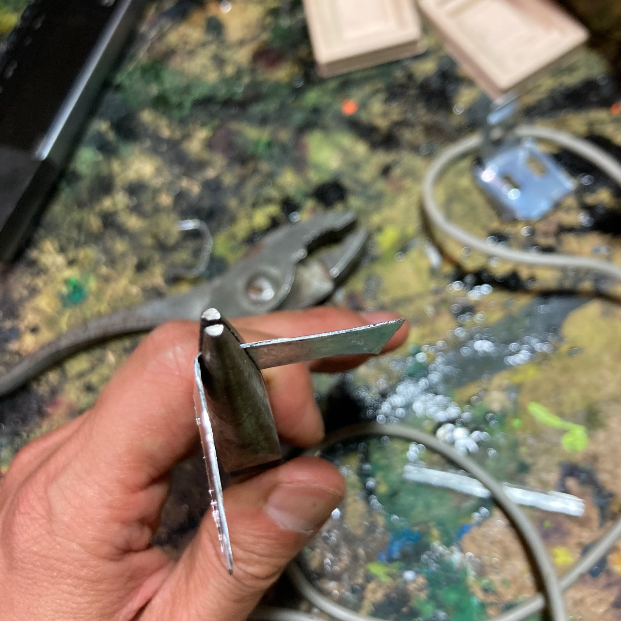 Strip of sheet metal being bent into a U-shaped clip fitting to a car stereo face