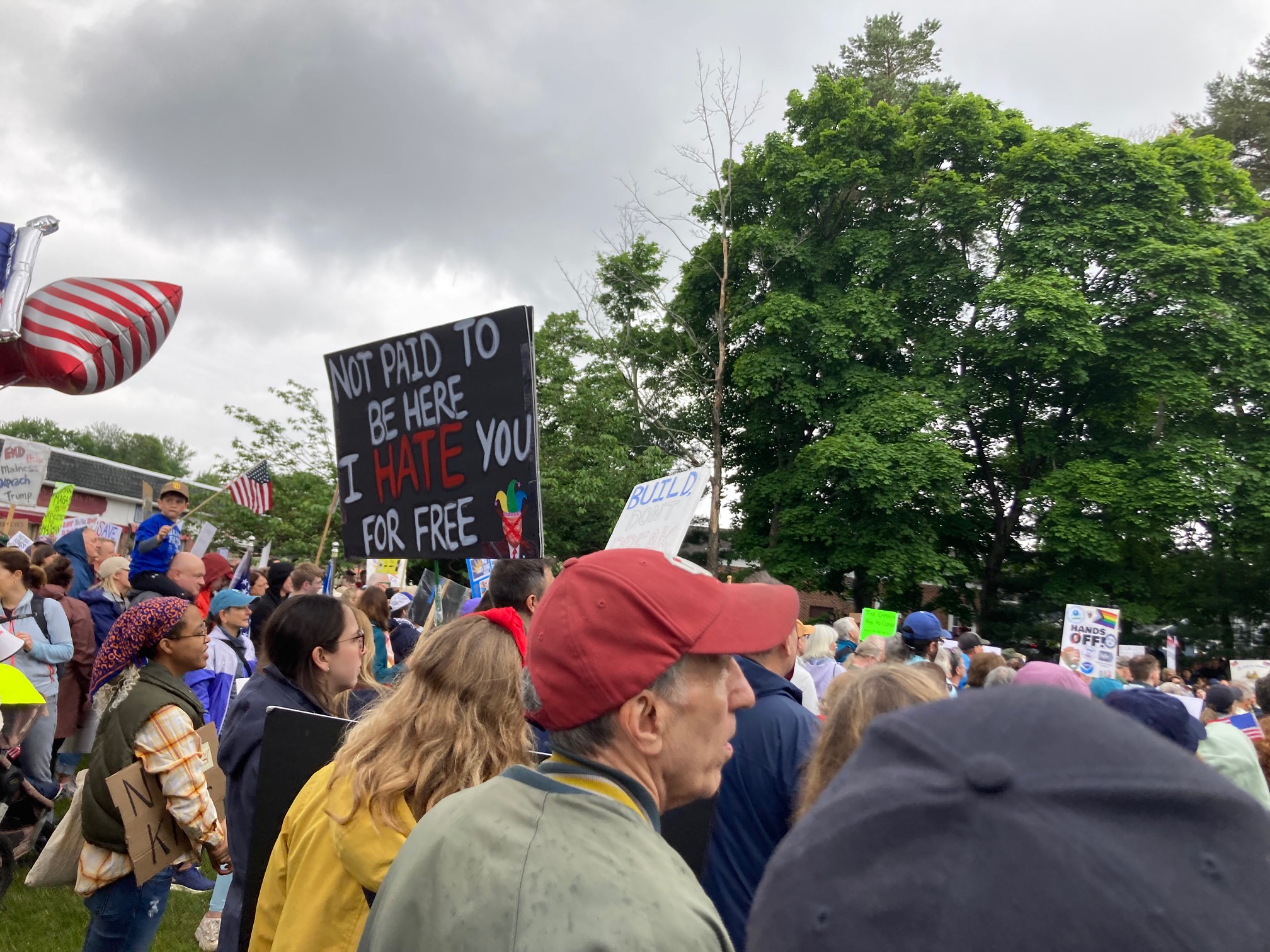 “not paid to be here, I hate you for free” sign