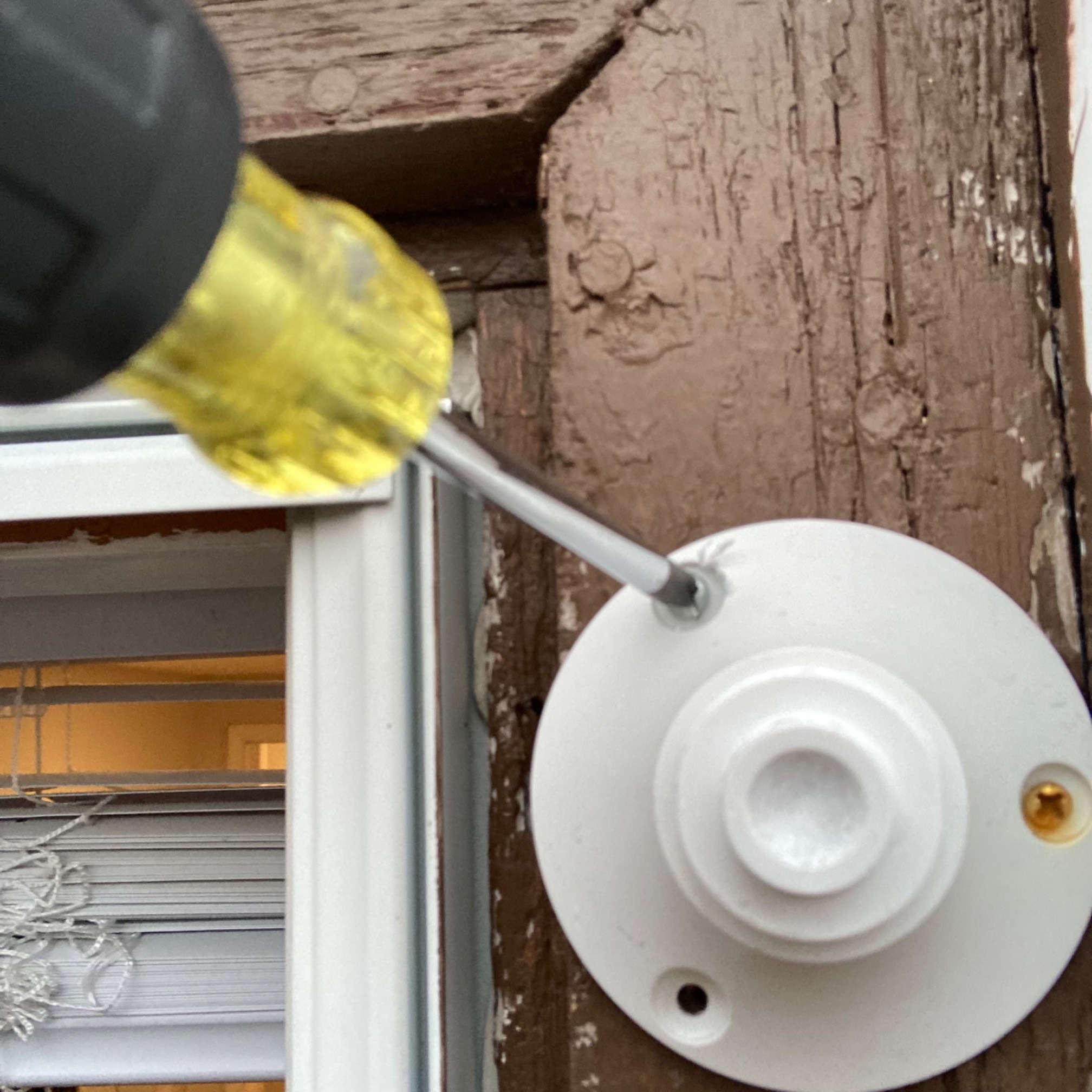 Outside of window with ring on trim fastened by screws