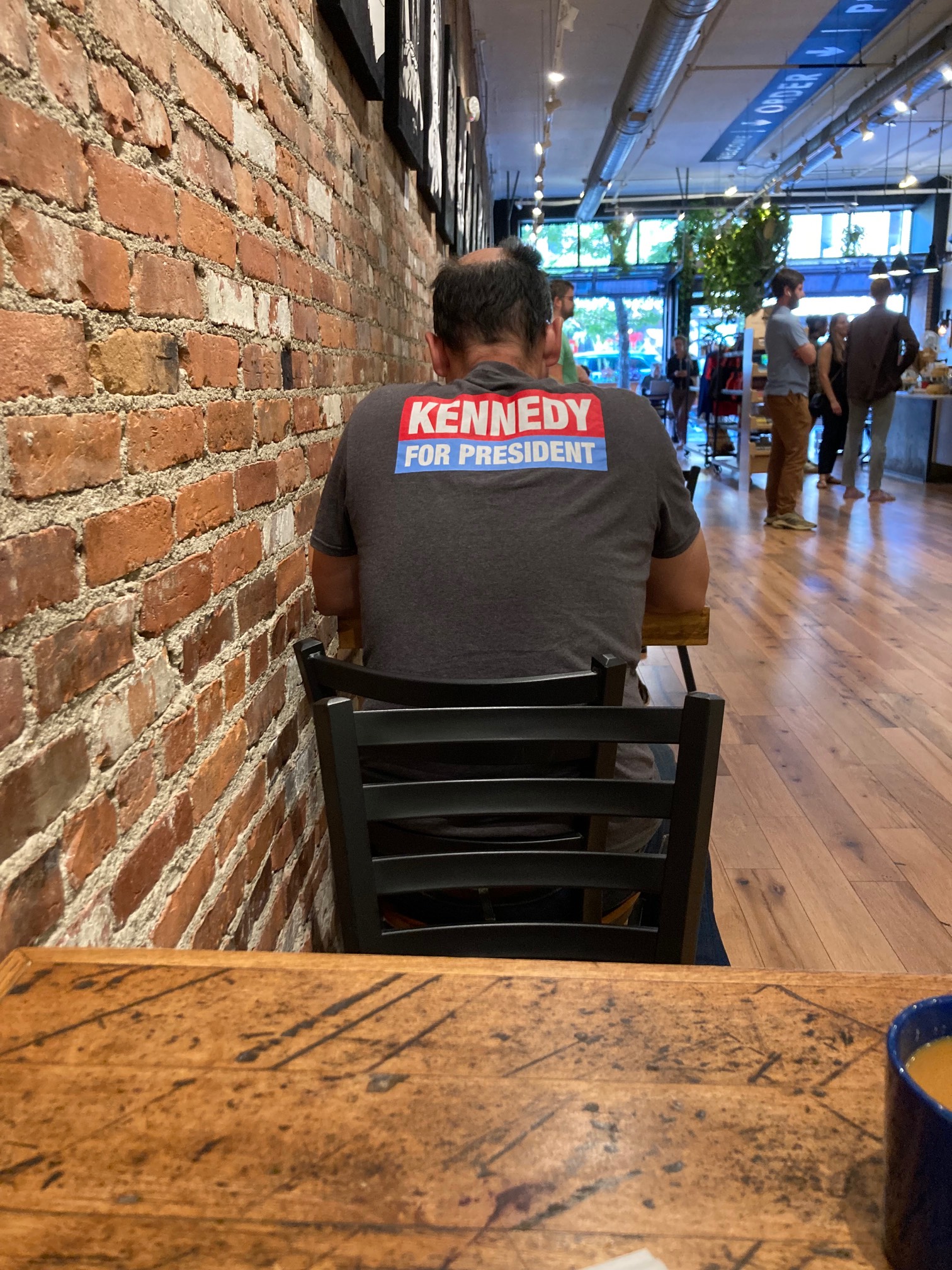 Kennedy for President (and it is Joe Kennedy on the front of the shirt) guy seems to be reading alou