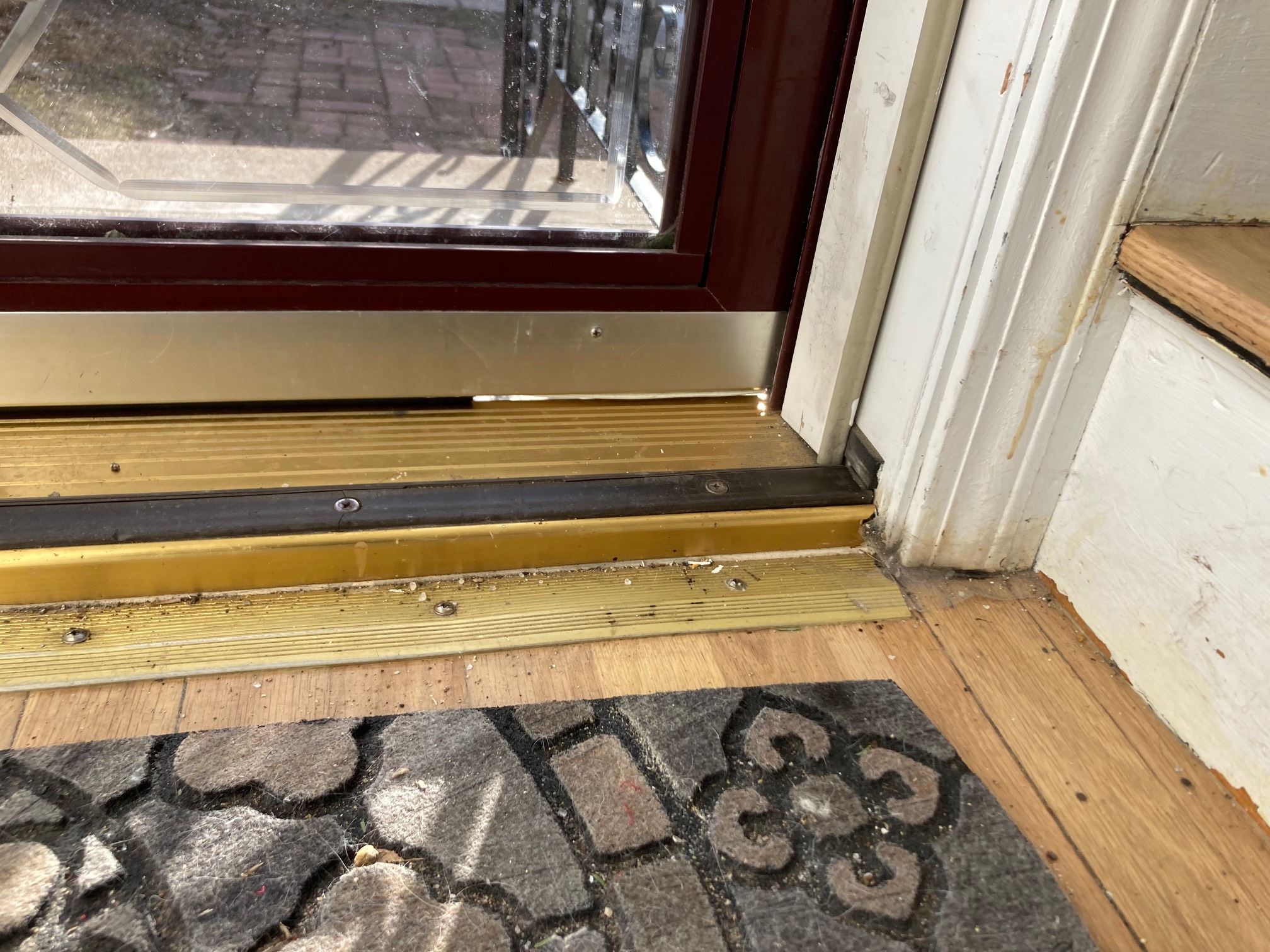 Storm door with light coming in through a gap at the bottom