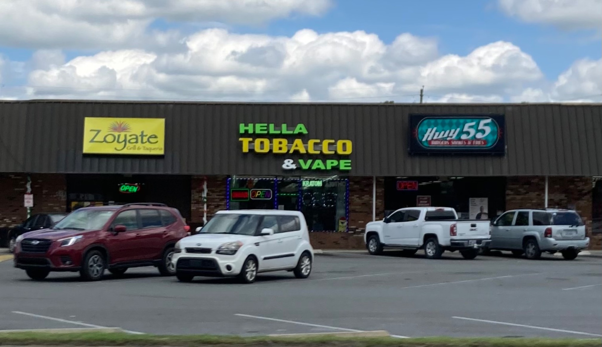 Hella Tobacco & Vape strip mall sign
