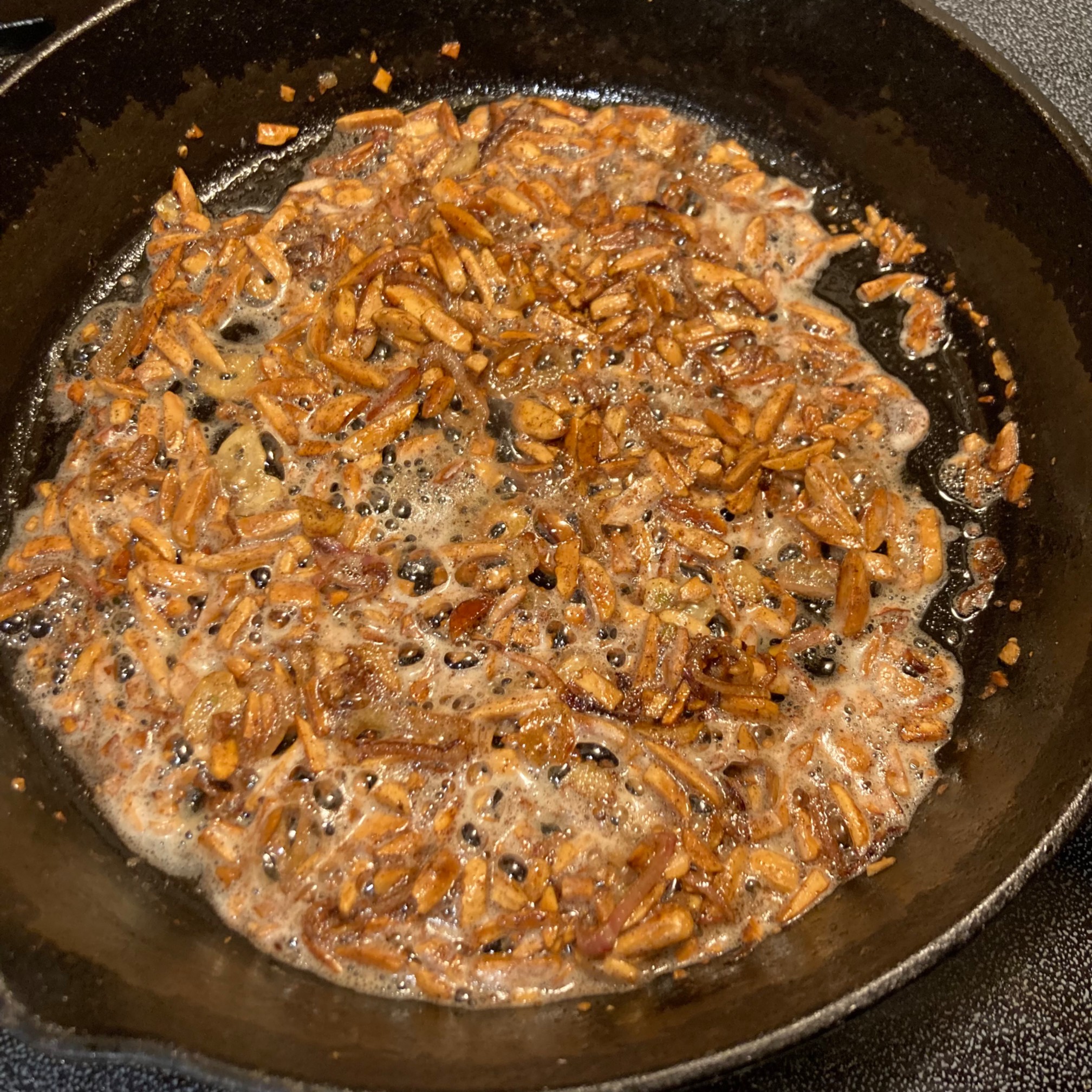 Toasted almonds in a pan with butter