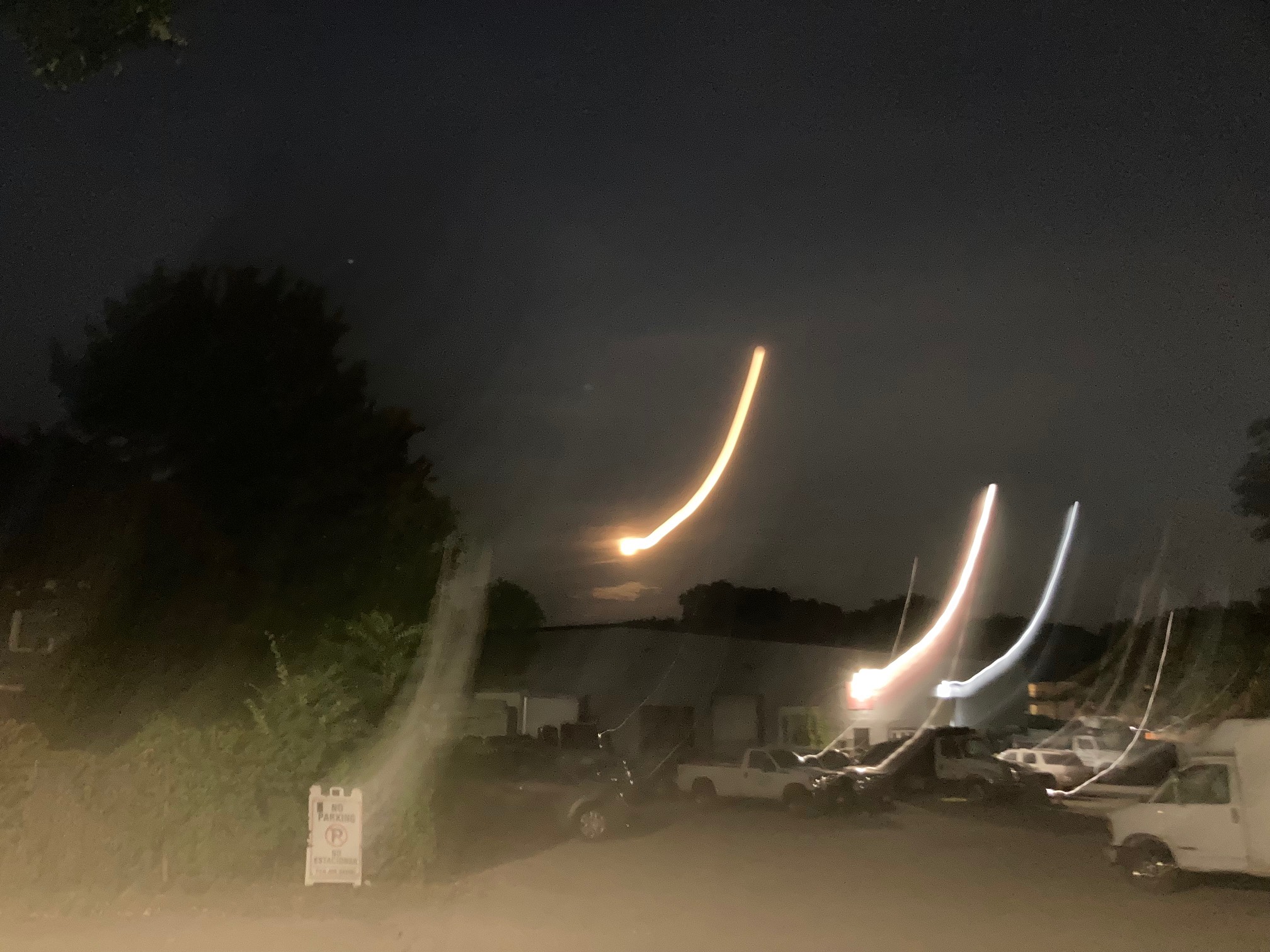 Night scene with light streaks where the moon and street lamps should be