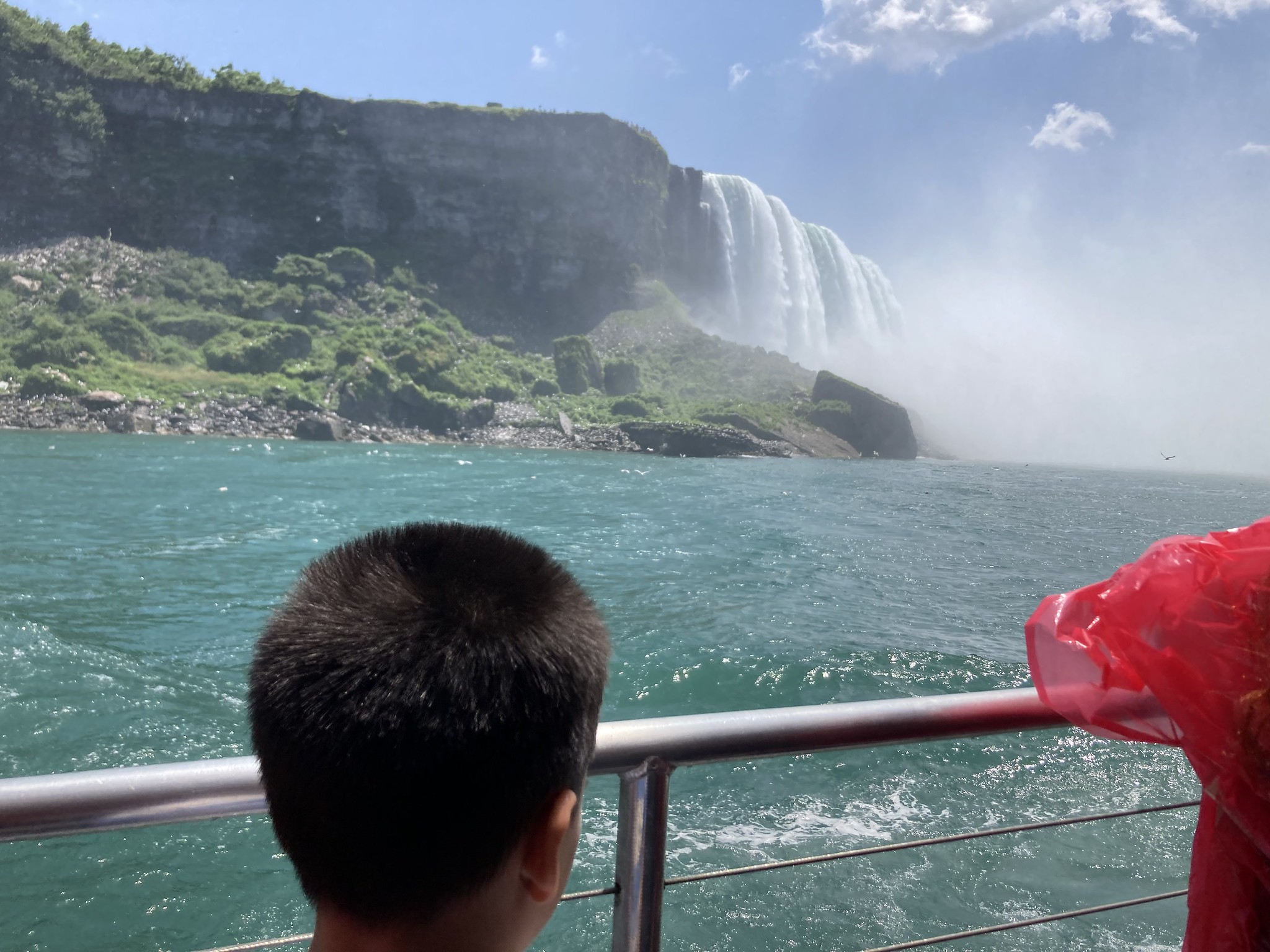 Kid looking at a waterfall
