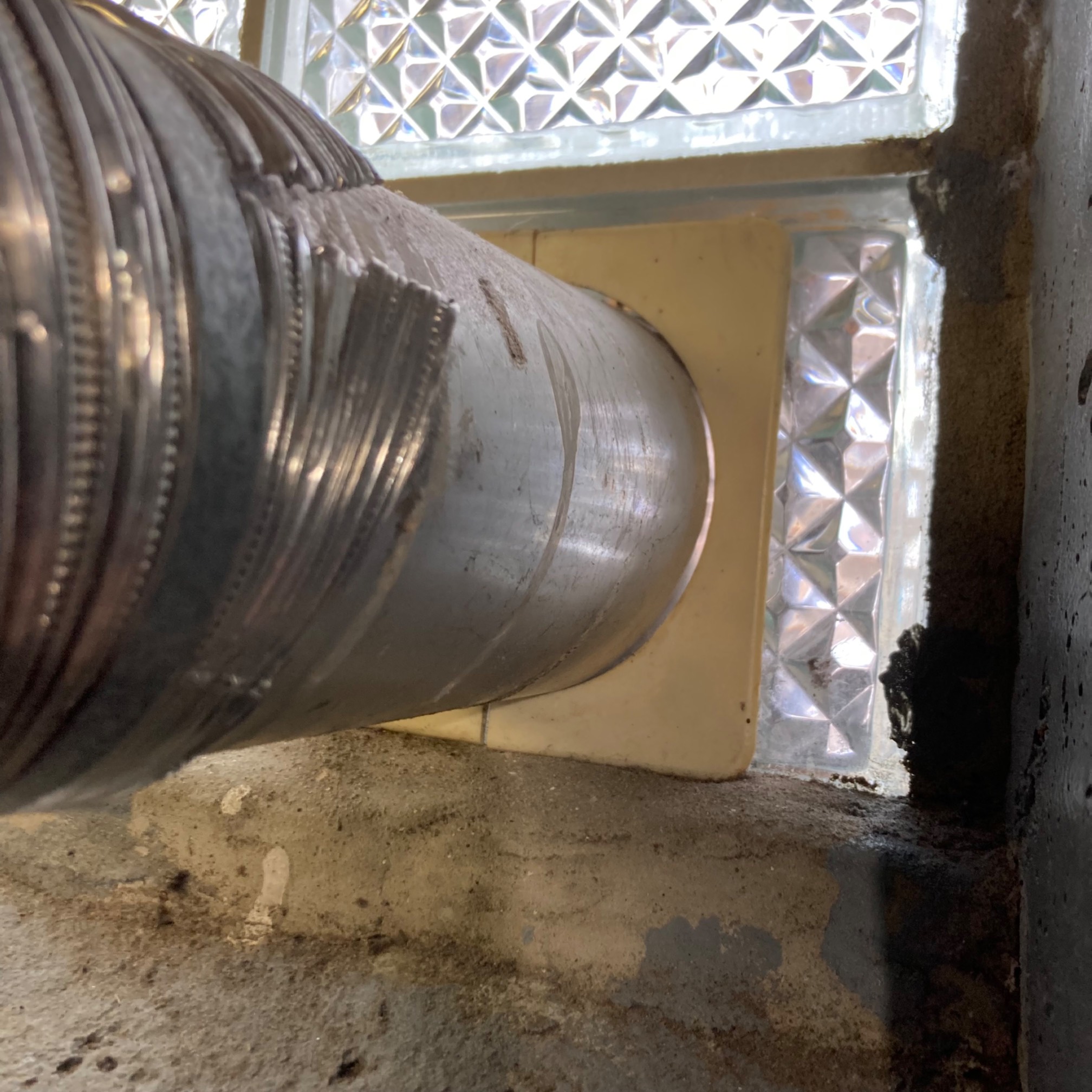 Pipe going through glass window with plastic plate 