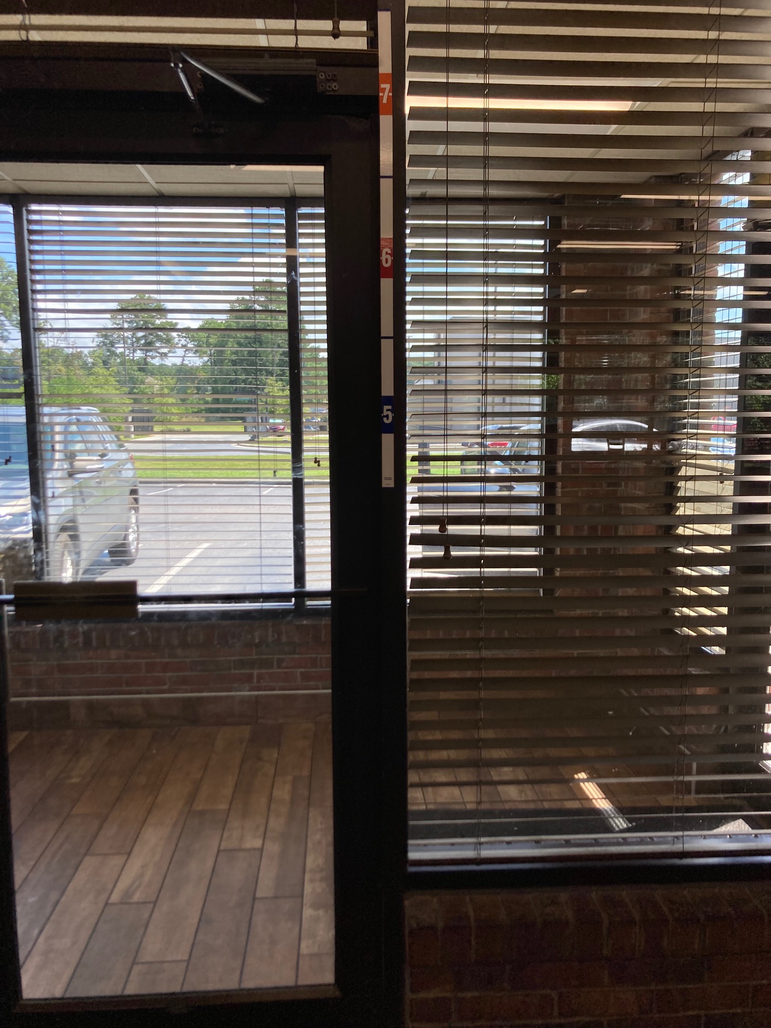 Restaurant exit with tape next to door with height measurements that begin at 4’6”
