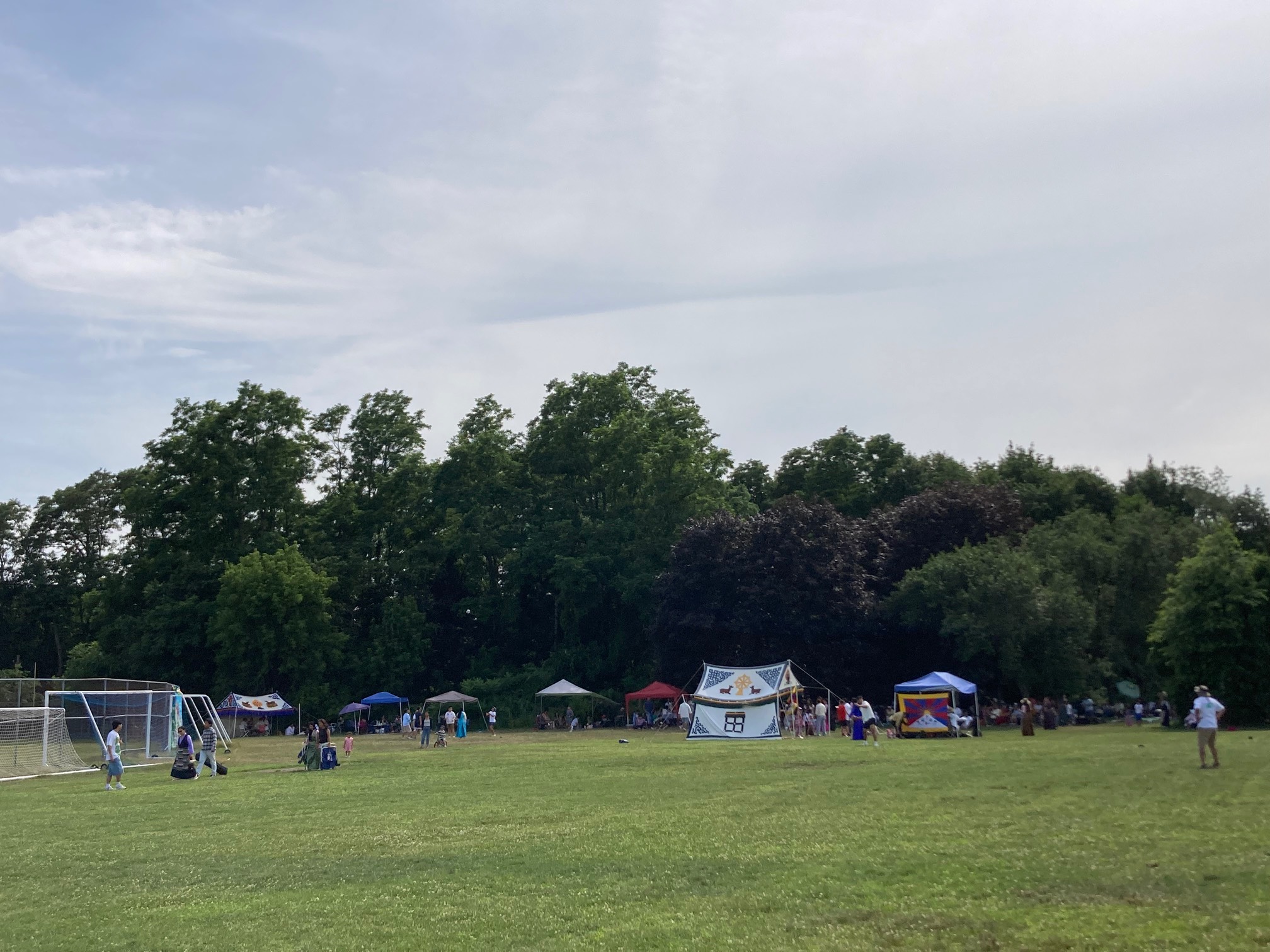 Tents on field, one with the flag of Nepal