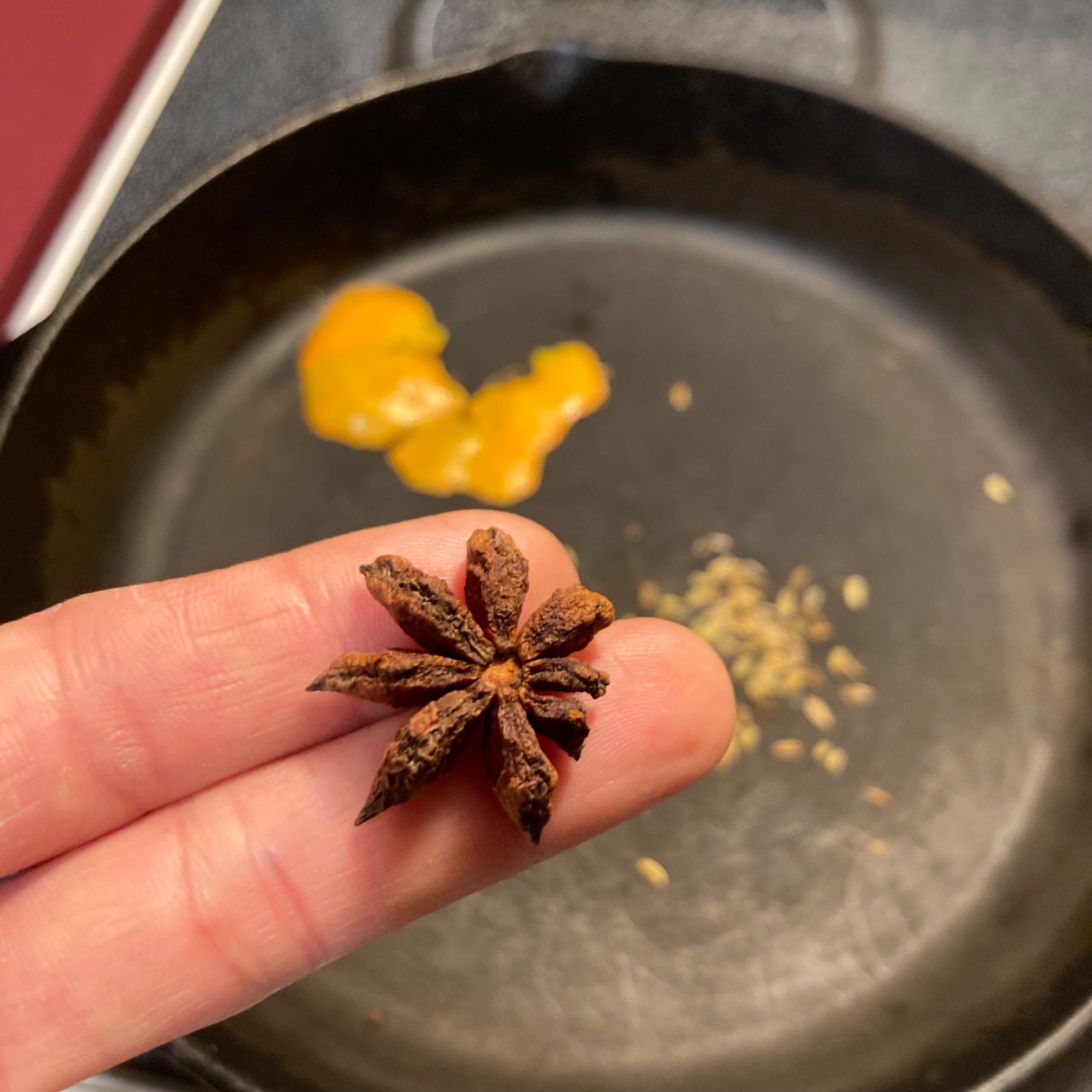 Star anise pod and spices toasting in pan