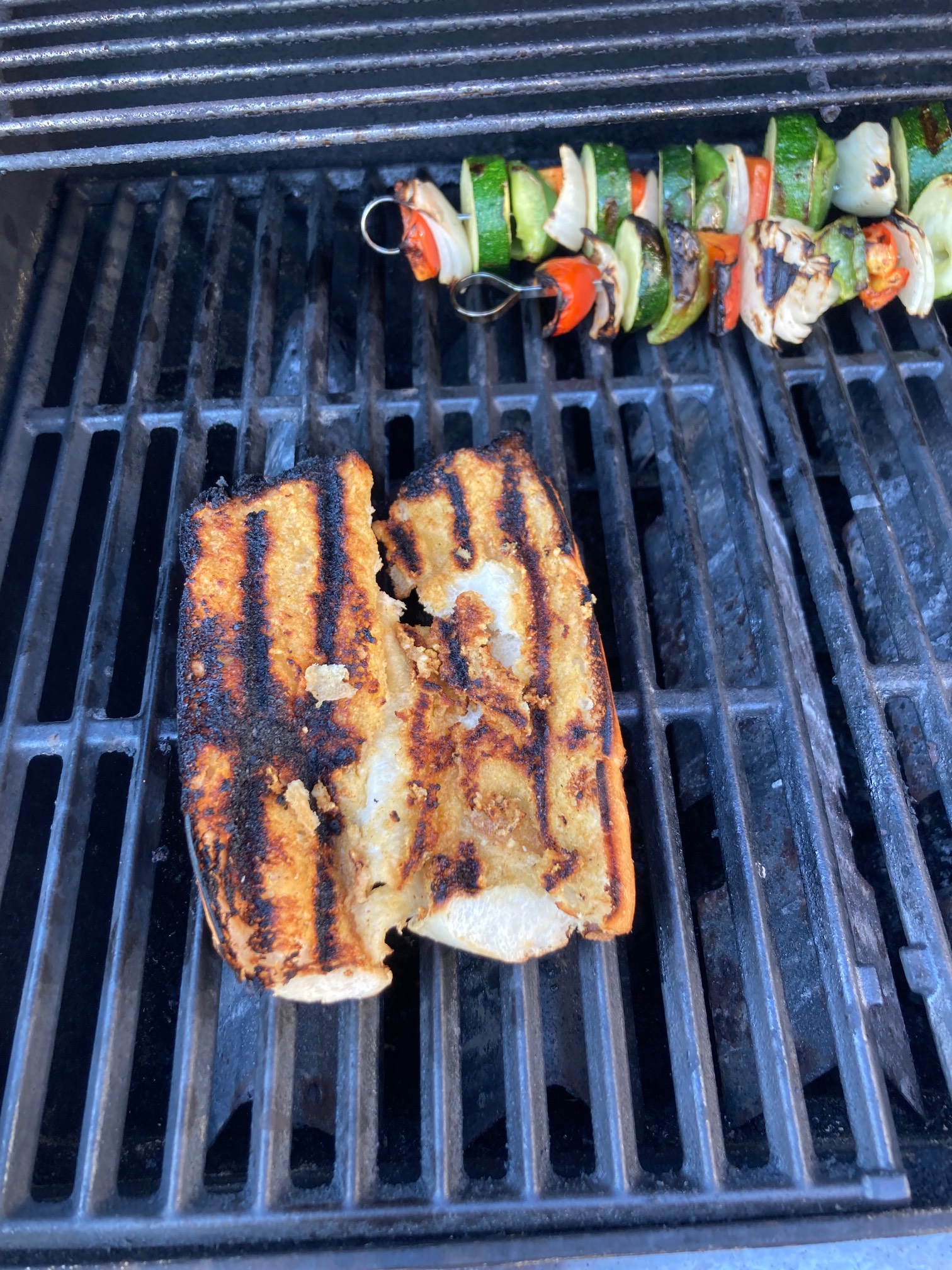 Garlic bread and vegetable skewer on grill