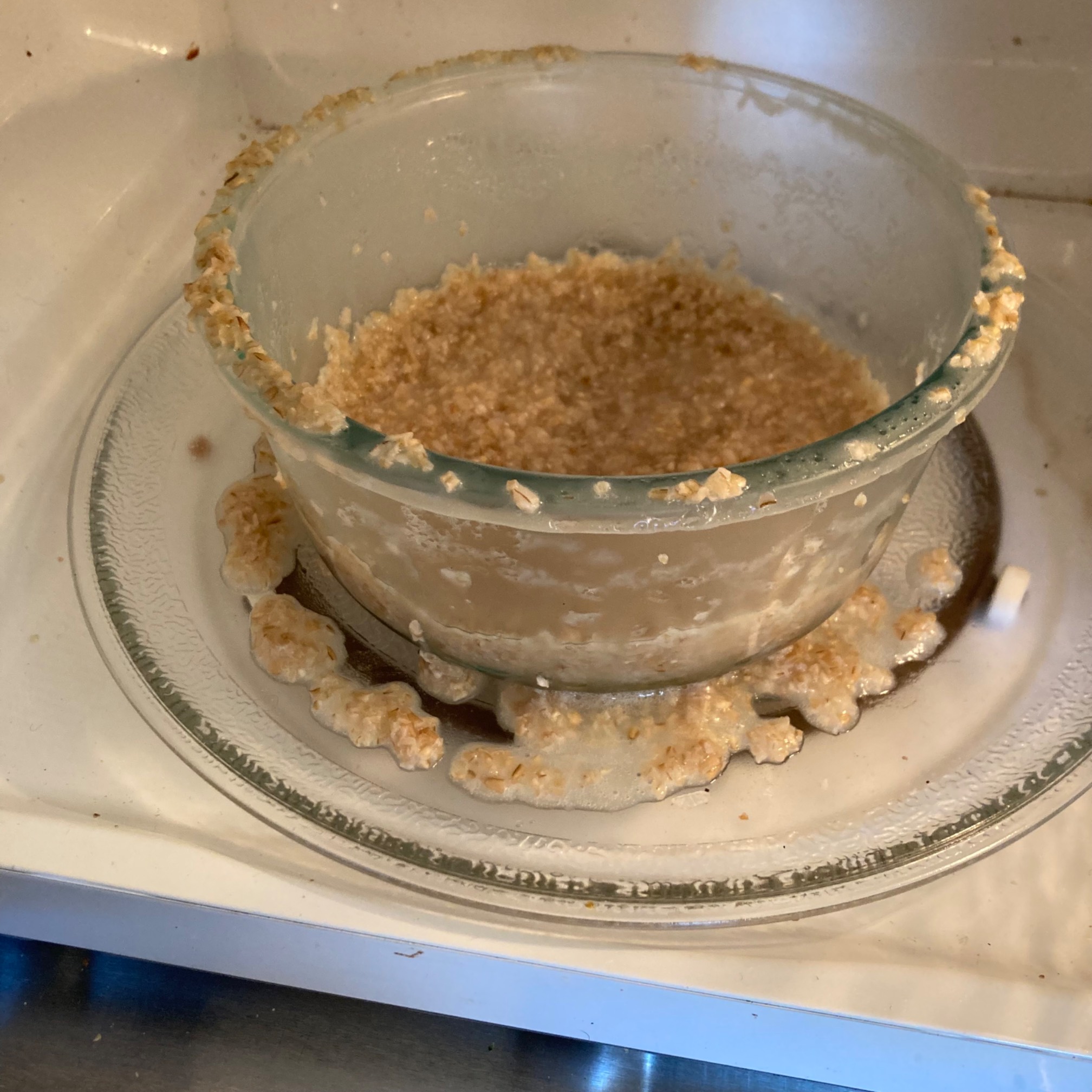 Bowl in microwave with overflow outside of it