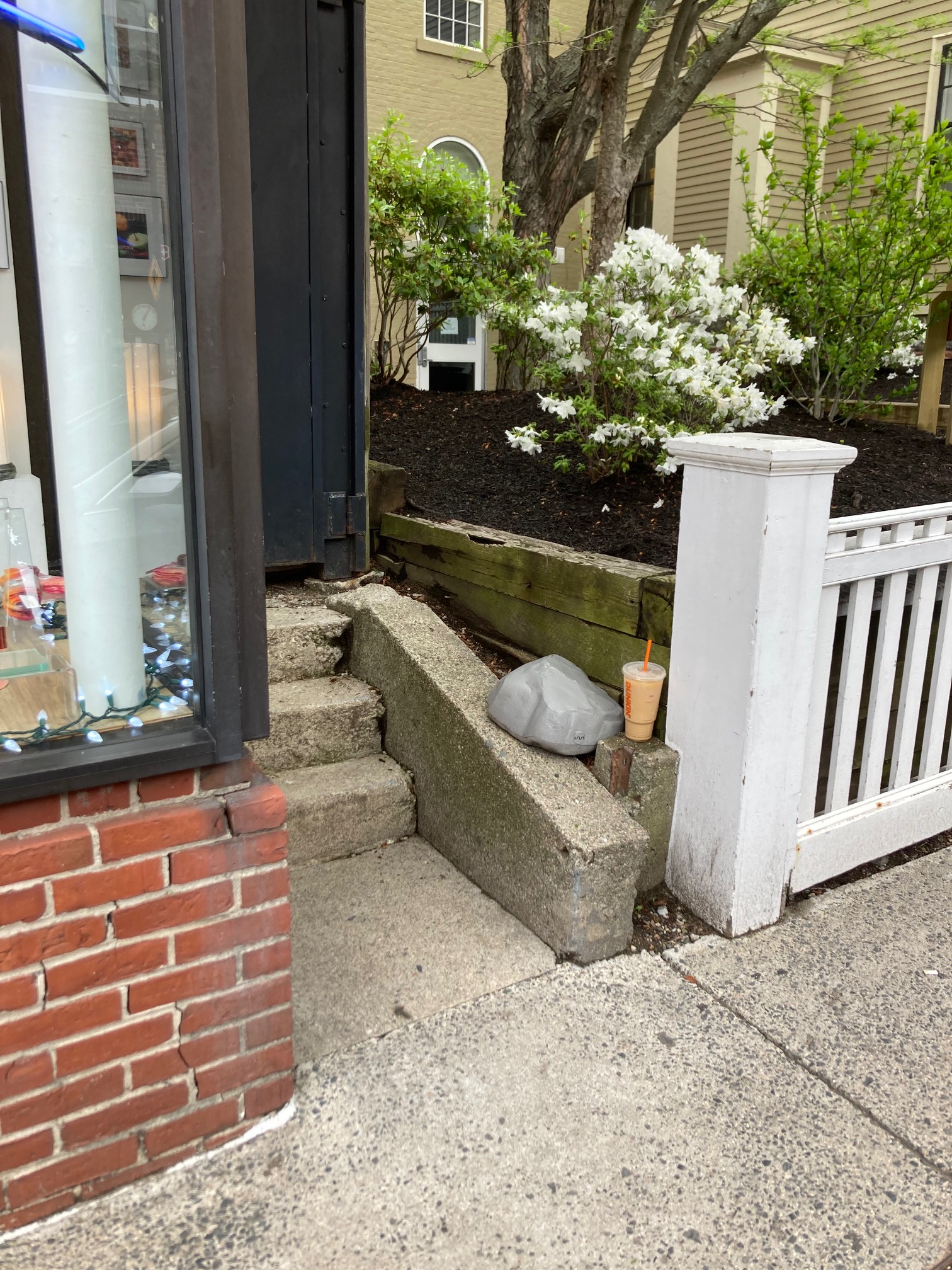 Iced coffee left on a low wall