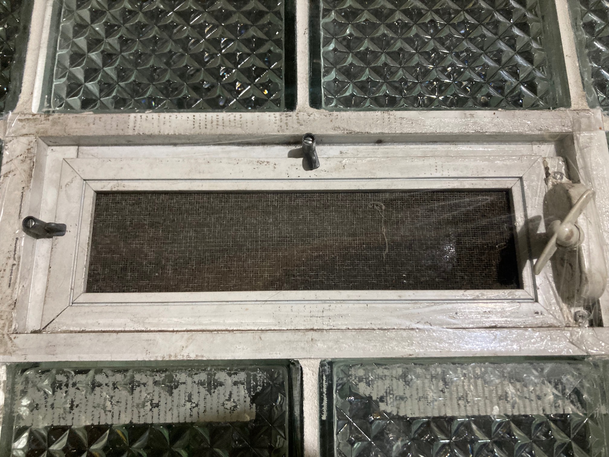 Small rectangular window covered in clear plastic