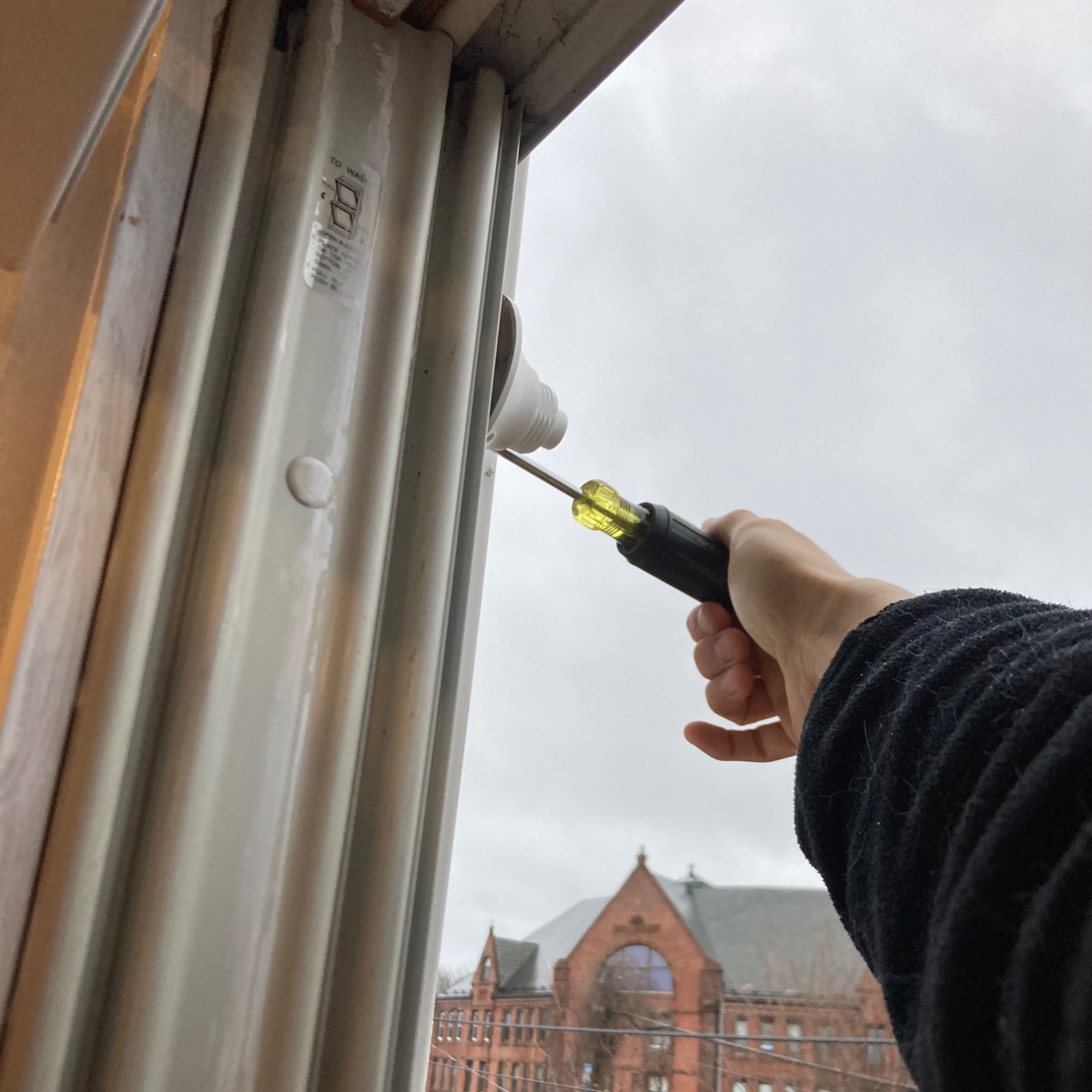 View from inside window of a screwdriver connecting with ring