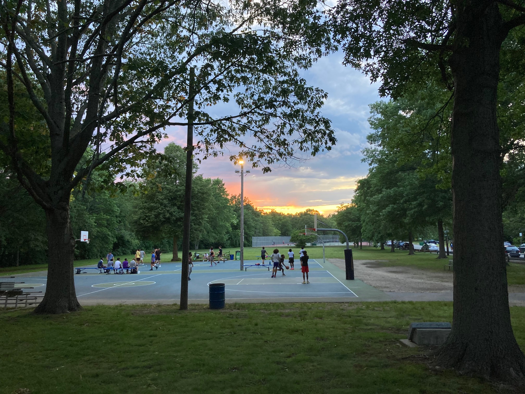Basketball participants at sunset