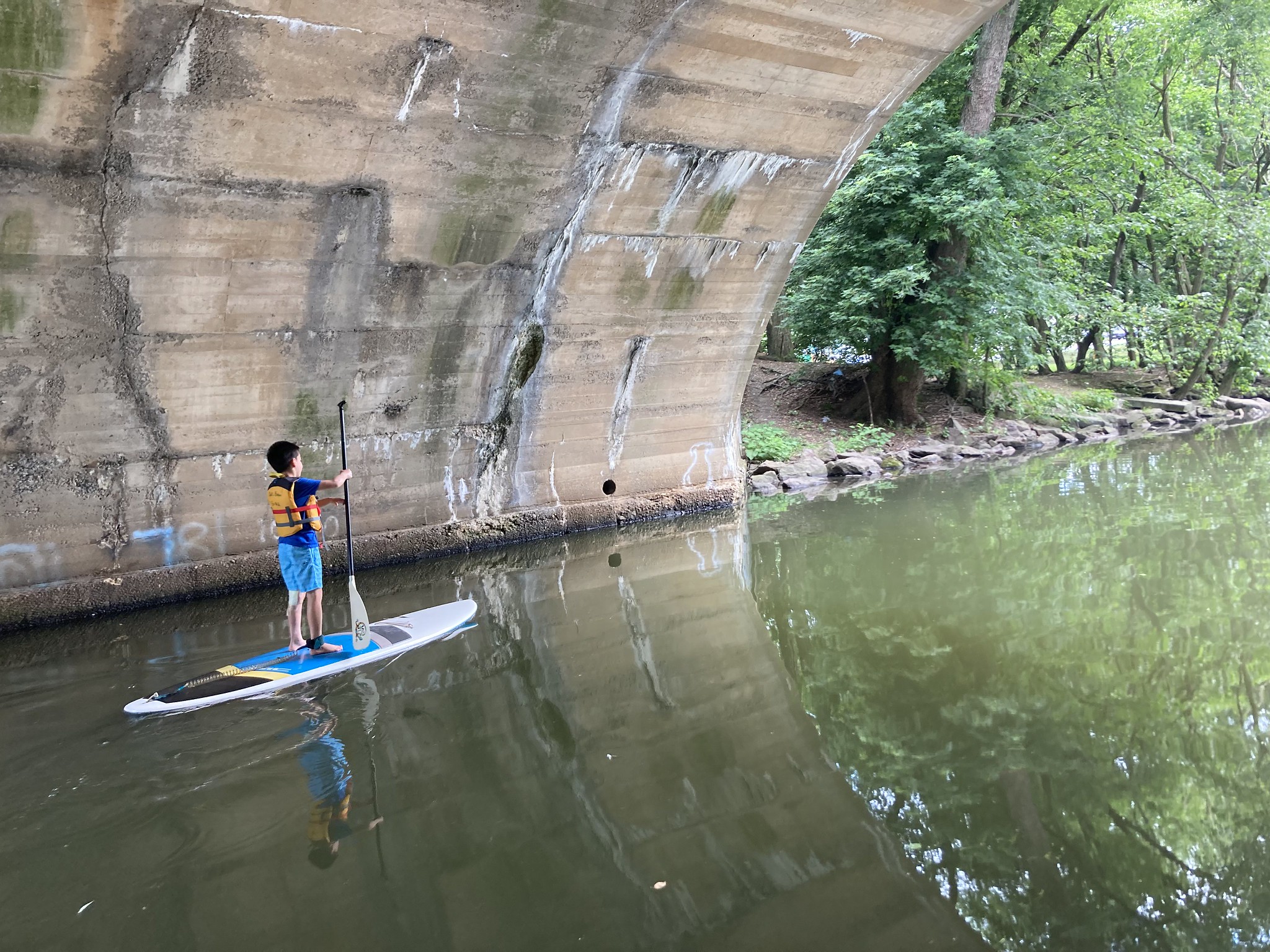 Person on paddleboard in tunnel