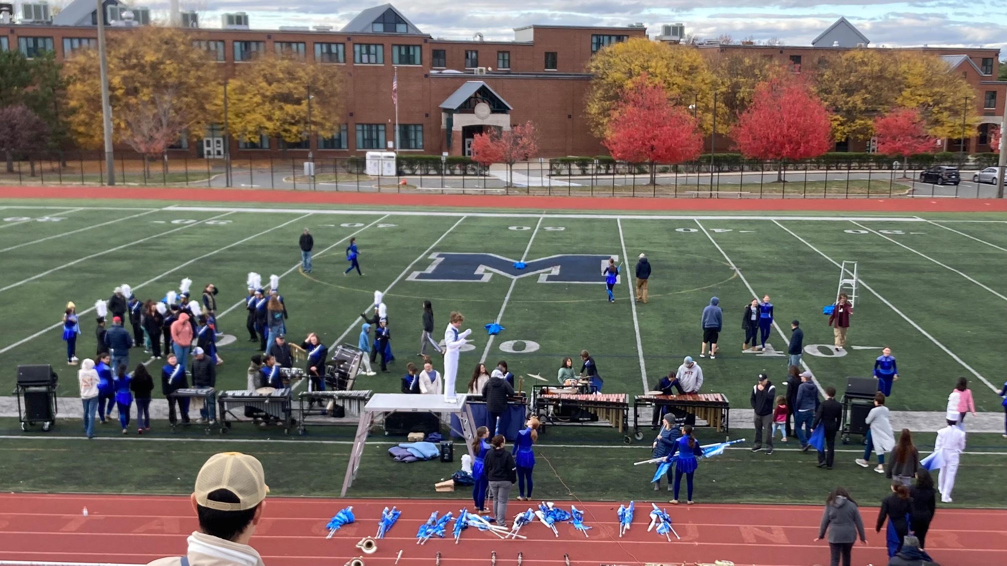 Several people on a field with various instruments and implements