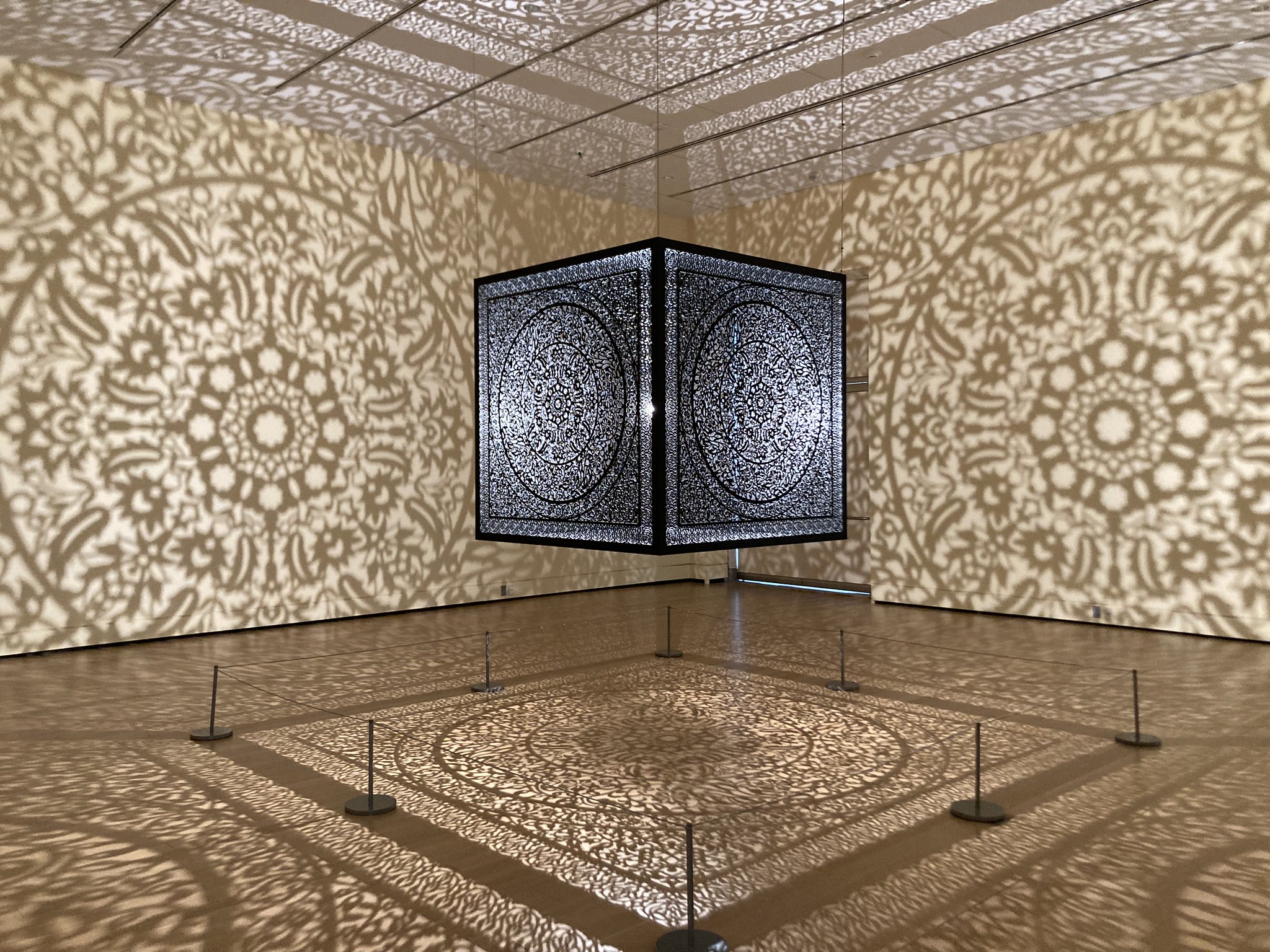 Hanging cube projecting patterns on the wall