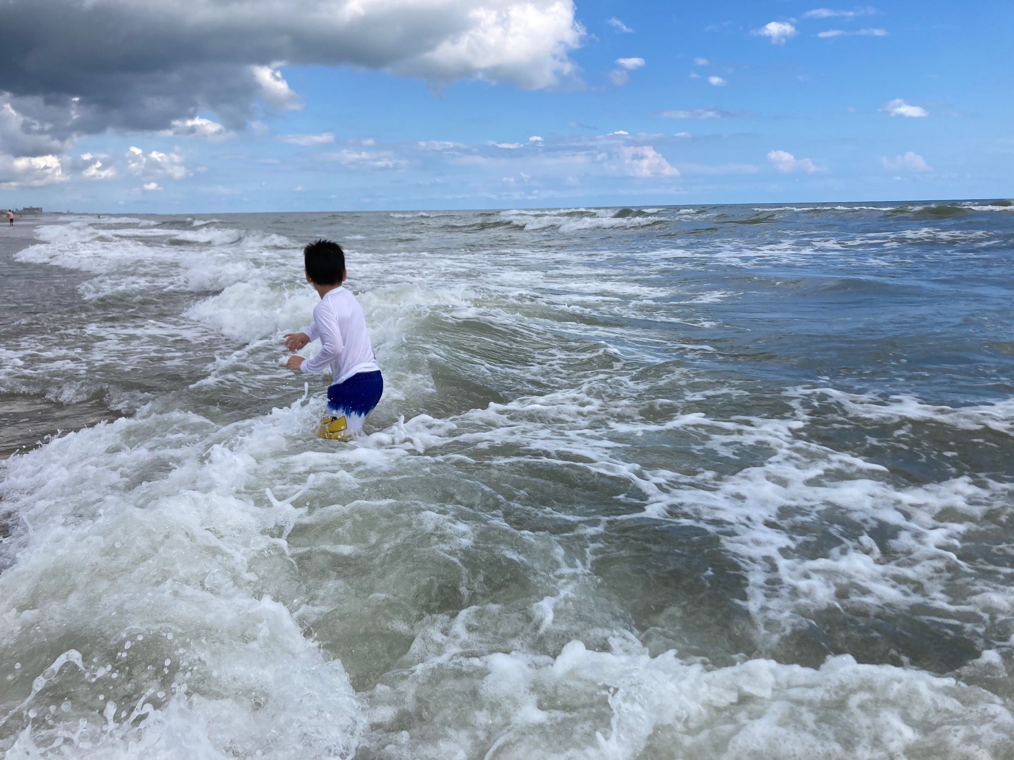Waves crashing around child